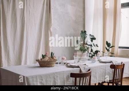 Table setting with pink hyacinths and spring flowers Stock Photo