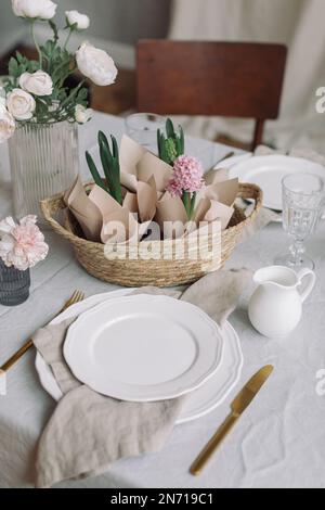 Close-up of a table setting with pink hyacinths and spring flowers Stock Photo