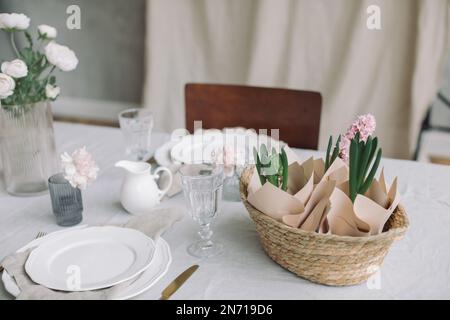 Close-up of a table setting with pink hyacinths and spring flowers Stock Photo