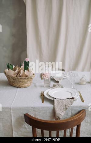 Close-up of a table setting with pink hyacinths Stock Photo