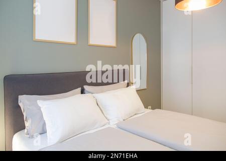 King size bed in simple and cozy bedroom. Stock Photo