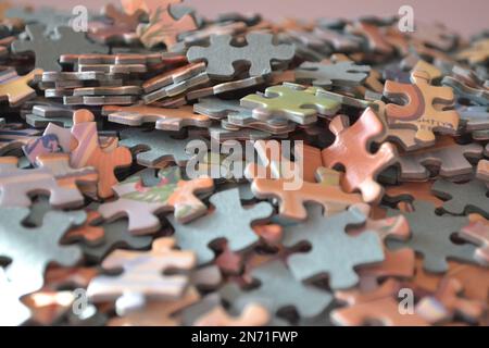 Jigsaw Puzzle Pieces In A Pile All Together - Sun Light On The Puzzle Pieces - UK Stock Photo