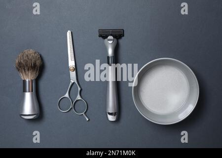 Set of men's shaving tools on dark grey background, flat lay Stock Photo