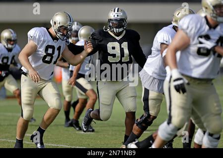 FILE - New Orleans Saints tight end Juwan Johnson (83) attempts to block Cleveland  Browns defensive end Myles Garrett (95) during an NFL football game,  Saturday, Dec. 24, 2022, in Cleveland. As