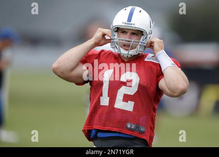 Indianapolis Colts quarterback Andrew Luck buckles his helmet during  practice at the NFL team's football training camp in Anderson, Ind.,  Tuesday, July 30, 2013. (AP Photo/Michael Conroy Stock Photo - Alamy