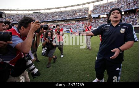 Former Argentina's soccer star Diego Maradona, left, shields the