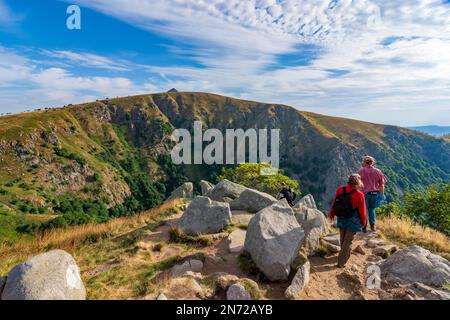 Vosges (Vogesen) Mountains, summit Hohneck, view to South to mountain basin Wormspelkessel, hiker in Alsace (Elsass), Haut-Rhin (Oberelsass), France Stock Photo