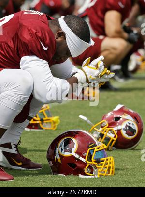 Dec. 24, 2011 - Landover, Maryland, U.S - Minnesota Vikings running back  Adrian Peterson (28) fights to break a tackle by Washington Redskins  outside linebacker Brian Orakpo (98) during Saturday afternoon's game