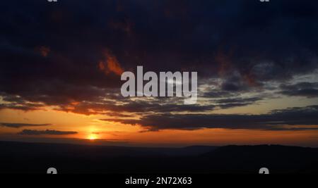 Fiery sunset view from Colley Hill between Reigate and Dorking in Surrey, UK. Surrey Hills area of Outstanding Natural Beauty on the North Downs. Stock Photo