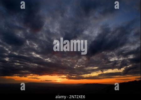 Dramatic sunset view from Colley Hill between Reigate and Dorking in Surrey, UK. Surrey Hills area of Outstanding Natural Beauty on the North Downs. Stock Photo
