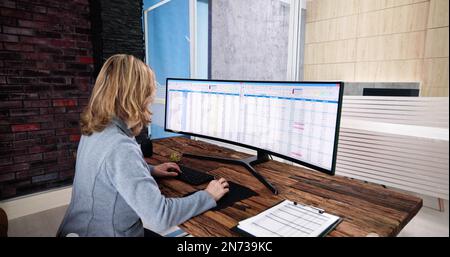 Data Analyst Woman Using Spreadsheet On Computer Stock Photo
