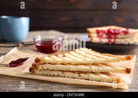 Tasty toasts served for breakfast on wooden table, closeup Stock Photo