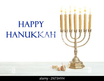 Happy Hanukkah. Traditional menorah and dreidels on wooden table Stock Photo