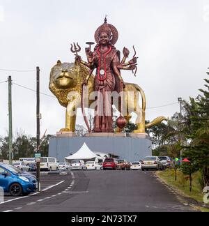 A powerful Statue of the Hindu goddess Durga Maa with a golden lion in sacred Ganga Talao. Grand bassin crater lake, Mauritius island. Stock Photo