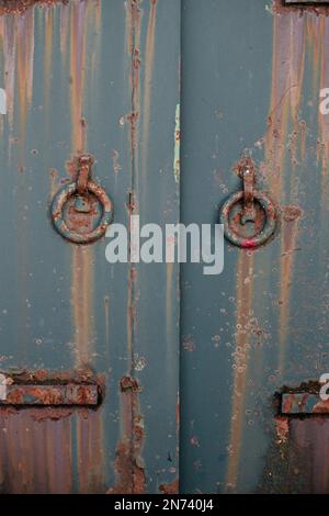 Rusty door with round handles Stock Photo