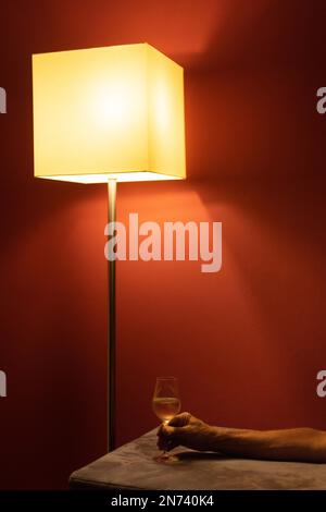 Hand of man holding wine glass in evening mood Stock Photo