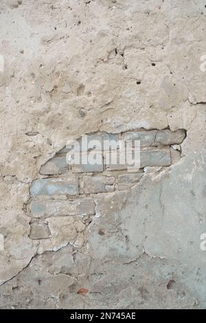 Old brick wall with peeling plaster Stock Photo