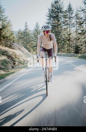 Professional triathlete with her road bike on a training lap in Black Forest, Baiersbronn, Germany Stock Photo