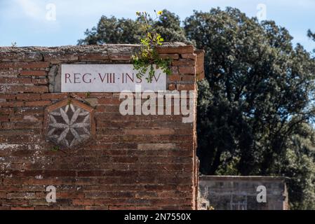 Sign with the street's name in ancient Pompeii and a fresco decoration on a wall, Southern Italy Stock Photo