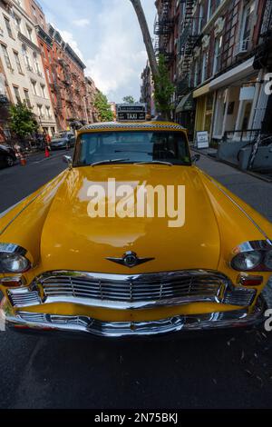 Classic Yellow Taxies park on the street at East Village in New York USA. Stock Photo