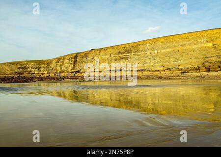 Wet Sand Reflecting Cliff Dunraven Bay Glamorgan Heritage Coast south Wales Stock Photo