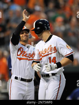 Baltimore Orioles' Brian Roberts congratulates Melvin Mora after Mora hit a  two-run homer, scoring Roberts, off Houston Astros pitcher Wandy Rodriguez  in the first inning Wednesday, June 15, 2005, in Baltimore.(AP Photo/Gail