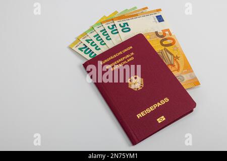 Passport of the Federal Republic of Germany with various euro bills, white background, Stock Photo