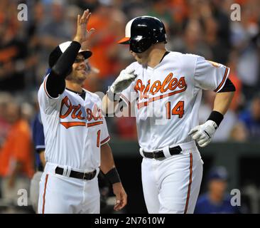 Baltimore Orioles' Brian Roberts congratulates Melvin Mora after Mora hit a  two-run homer, scoring Roberts, off Houston Astros pitcher Wandy Rodriguez  in the first inning Wednesday, June 15, 2005, in Baltimore.(AP Photo/Gail