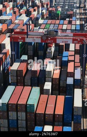 Stacked shipping containers wait to move by Automated Staking Cranes ...