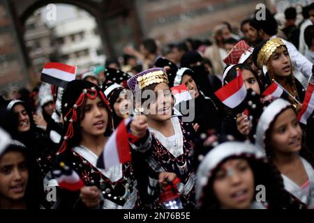 Yemeni girls wearing traditional costumes, attend a festival for