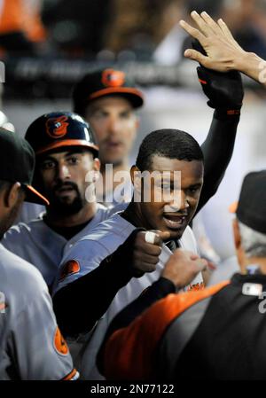 Baltimore Orioles outfielders, from left to right, Felix Pie, Nick Markakis  and Adam Jones celebrate after defeating the Texas Rangers 5-0 in the first  baseball game of a doubleheader on Saturday, April