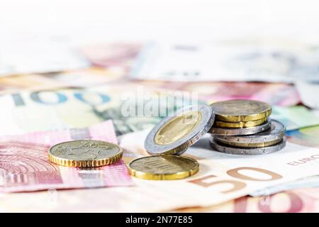 Money. Some euro coins on blurry banknotes. Economy concept for currency, business, home finance and inflation, copy space, selected focus, very narro Stock Photo