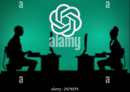 INDIA, NEW DELHI. JANUARY 30, 2023: Open AI. Leading the Way in Technology: Silhouette of Two Developers and Company Logo Showcased Stock Photo