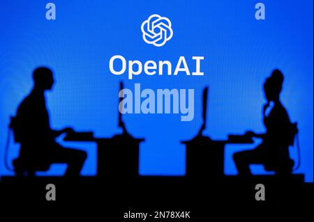 INDIA, NEW DELHI. JANUARY 30, 2023: Open AI. Collaboration Leads to Progress: Two Developers Working Together Under the Company's Logo Stock Photo