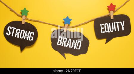 Strong brand equity symbol. Concept words Strong brand equity on wooden blocks on a beautiful black table black background. Business, finacial and str Stock Photo