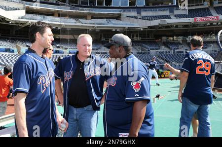 Hall of Fame ball player Tony Gwynn signs a 1998 jersey during pregame  activities for a reunion of the Padres' National League Championship team  before a baseball game in San Diego, Friday