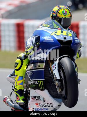 Doha, Qatar. 18th March, 2016. Valentino Rossi of Italy and Yamaha Factory  Racing performs a wheelie during MotoGP of Qatar - at Losail Circuit on  March 18, 2016 in Doha, Qatar. (Photo