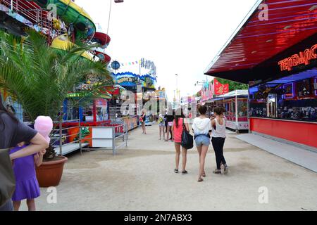 people enjoying the carnival fair in Paris. Stock Photo