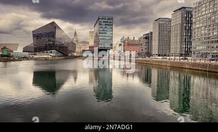 Modern buildings that make up Liverpool's waterfront. Taken from the Albert Dock looking down river towards the Liver Building. Stock Photo