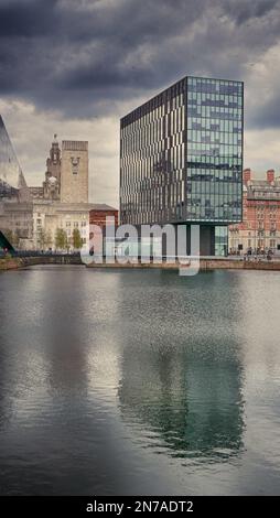 Modern buildings that make up Liverpool's waterfront. Taken from the Albert Dock looking down river towards the Liver Building. Stock Photo