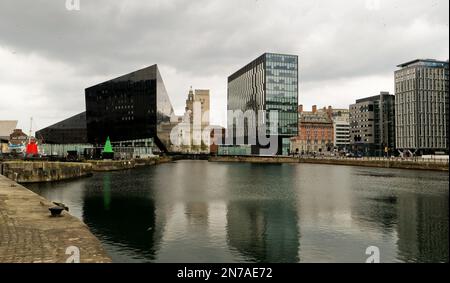 Modern buildings that make up Liverpool's waterfront. Taken from the Albert Dock looking down river towards the Liver Building. Stock Photo
