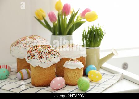 Traditional Easter cakes and dyed eggs on kitchen counter Stock Photo