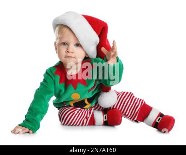 Cute baby in Santa's elf clothes sitting on white background. Christmas suit Stock Photo