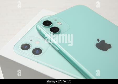 MYKOLAIV, UKRAINE - JULY 10, 2020: New modern Iphone 11 Green on original box, closeup Stock Photo