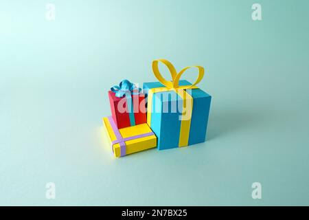 A group of gifts models and presents for Christmas, birthdays or Saint Valentine's Day made out of colored paper on a flat background Stock Photo