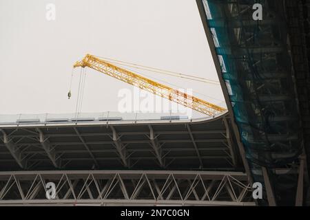 Building and improving the greatest football stadium with a crane in Spain, roof detail of the construction site. Santiago Bernabeu - Real Madrid Stock Photo