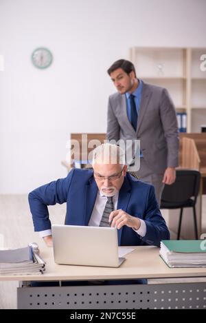 Two colleagues working at workplace Stock Photo