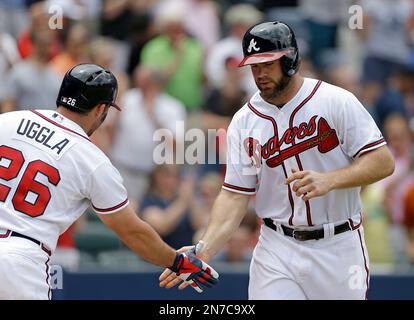 Atlanta Braves' Evan Gattis, right, is congratulated by Chris Johnson after  his solo home run against the San Diego Padres during the seventh inning of  a baseball game Monday, July 28, 2014
