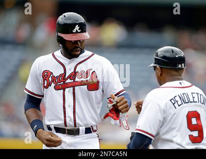 Atlanta Braves' Terry Pendleton, left, has a laugh with former Braves  Manager Bobby Cox, right, in the dugout as Braves Manager Fredi Gonzalez  looks on in the dugout prior to the baseball