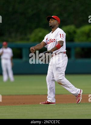 Philadelphia Phillies short stop Jimmy Rollins leaps into the air after  forcing Atlanta Braves runner Kelly Johnson at second base and completes  the double play in the seventh inning at Turner Field